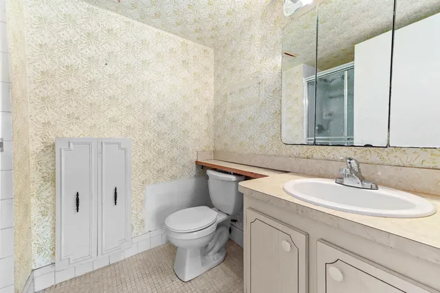 a bathroom with a sink a toilet and mirror