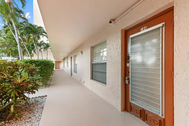 a view of a hallway with potted plants