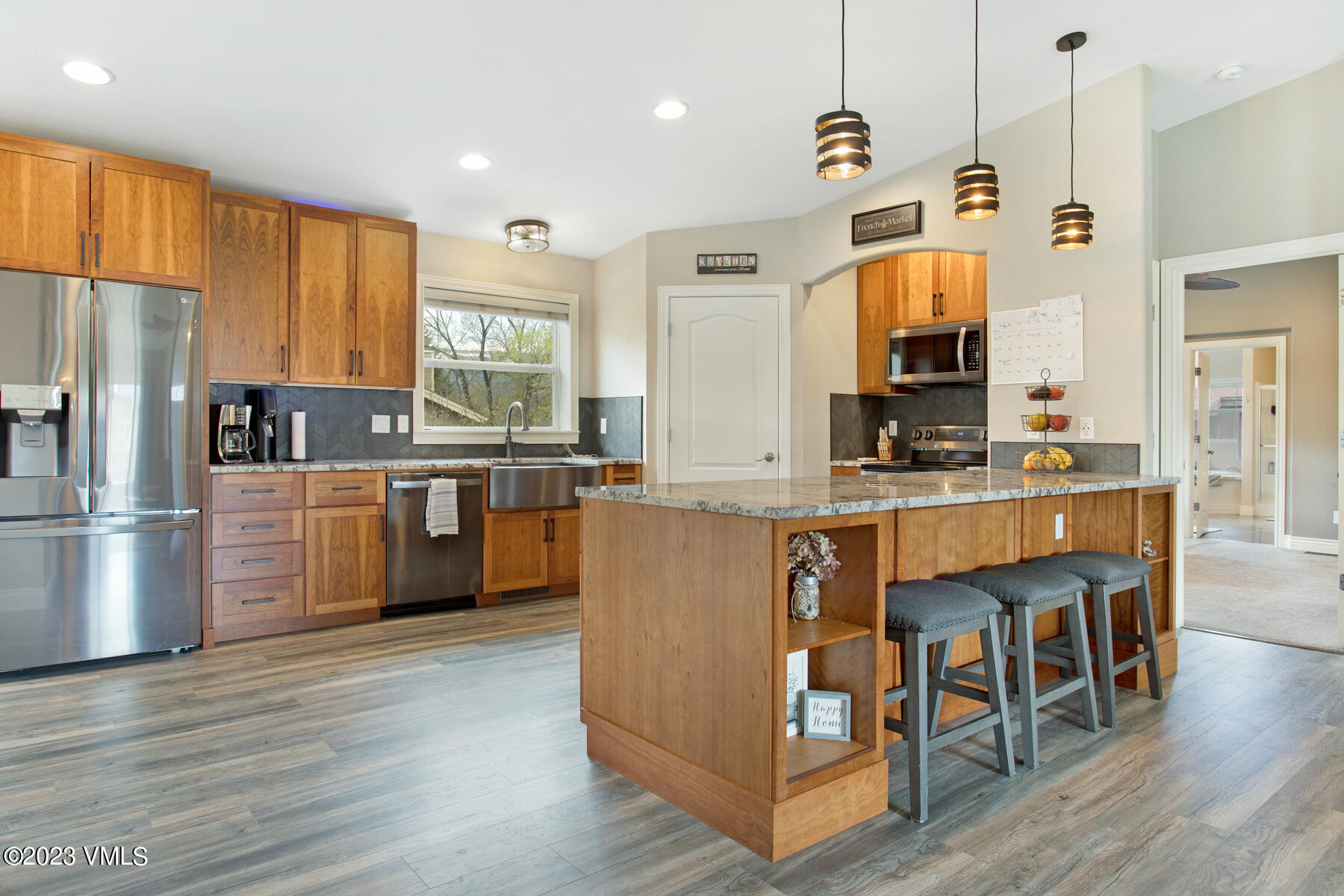 376 Blacksmith Road Eagle, CO 81631 - Photo 11 of 32 a kitchen with stainless steel appliances granite countertop a table chairs and a refrigerator