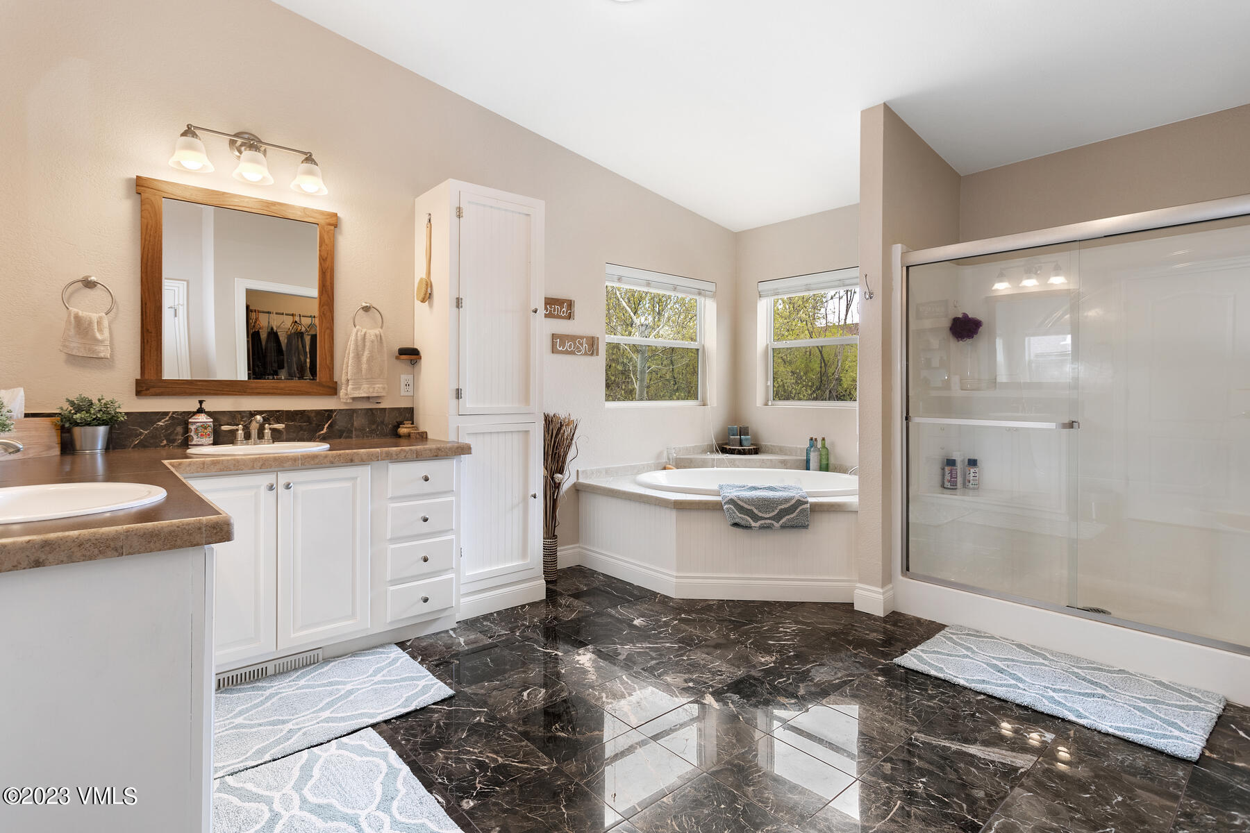 376 Blacksmith Road Eagle, CO 81631 - Photo 15 of 32 a bathroom with a double vanity sink a mirror and a bathtub