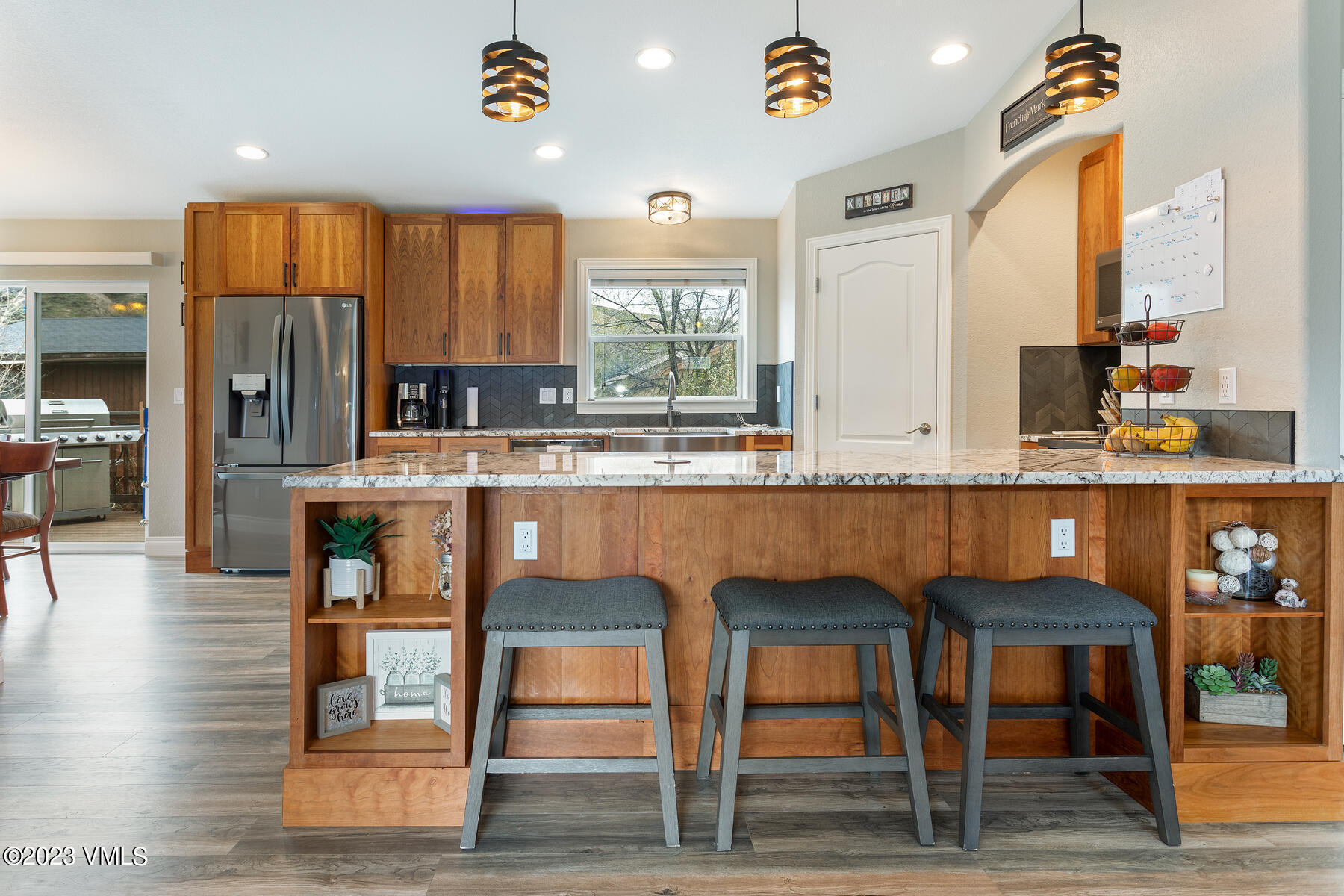 376 Blacksmith Road Eagle, CO 81631 - Photo 8 of 32 a kitchen with stainless steel appliances kitchen island granite countertop a table and chairs in it