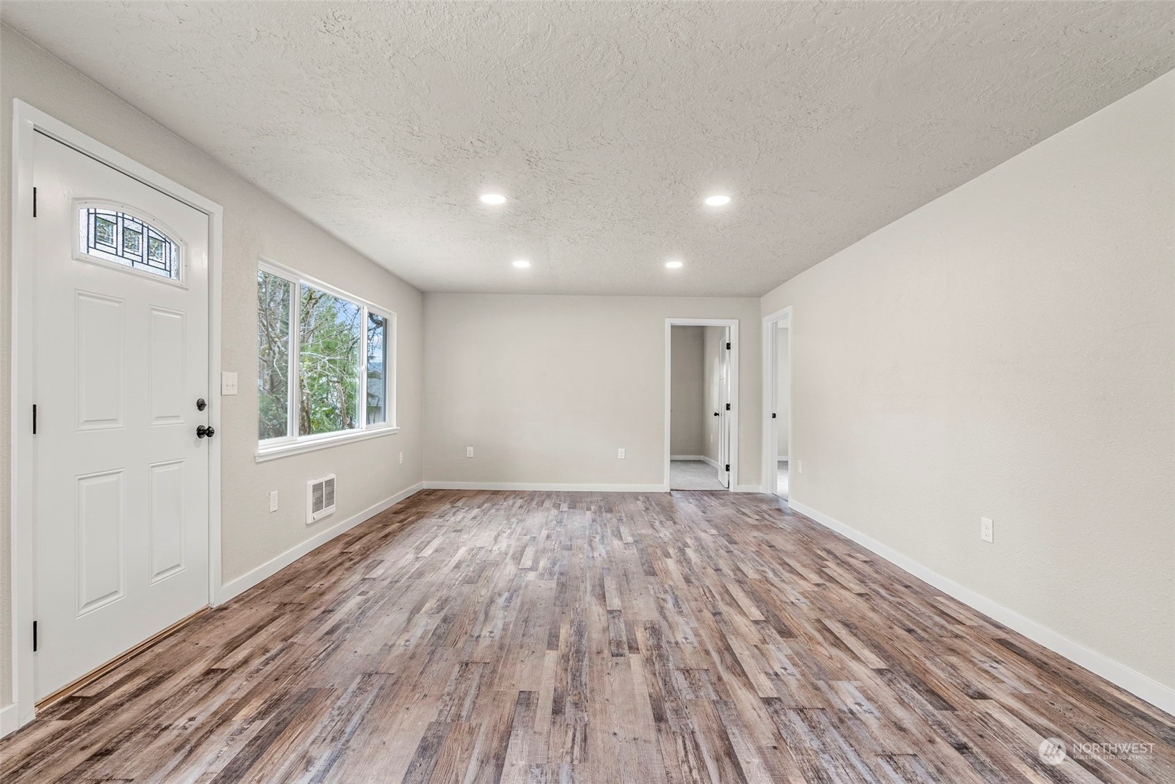 1541 Sightly Road Toutle, WA 98649 - Photo 11 of 30 a view of an empty room with wooden floor and a window