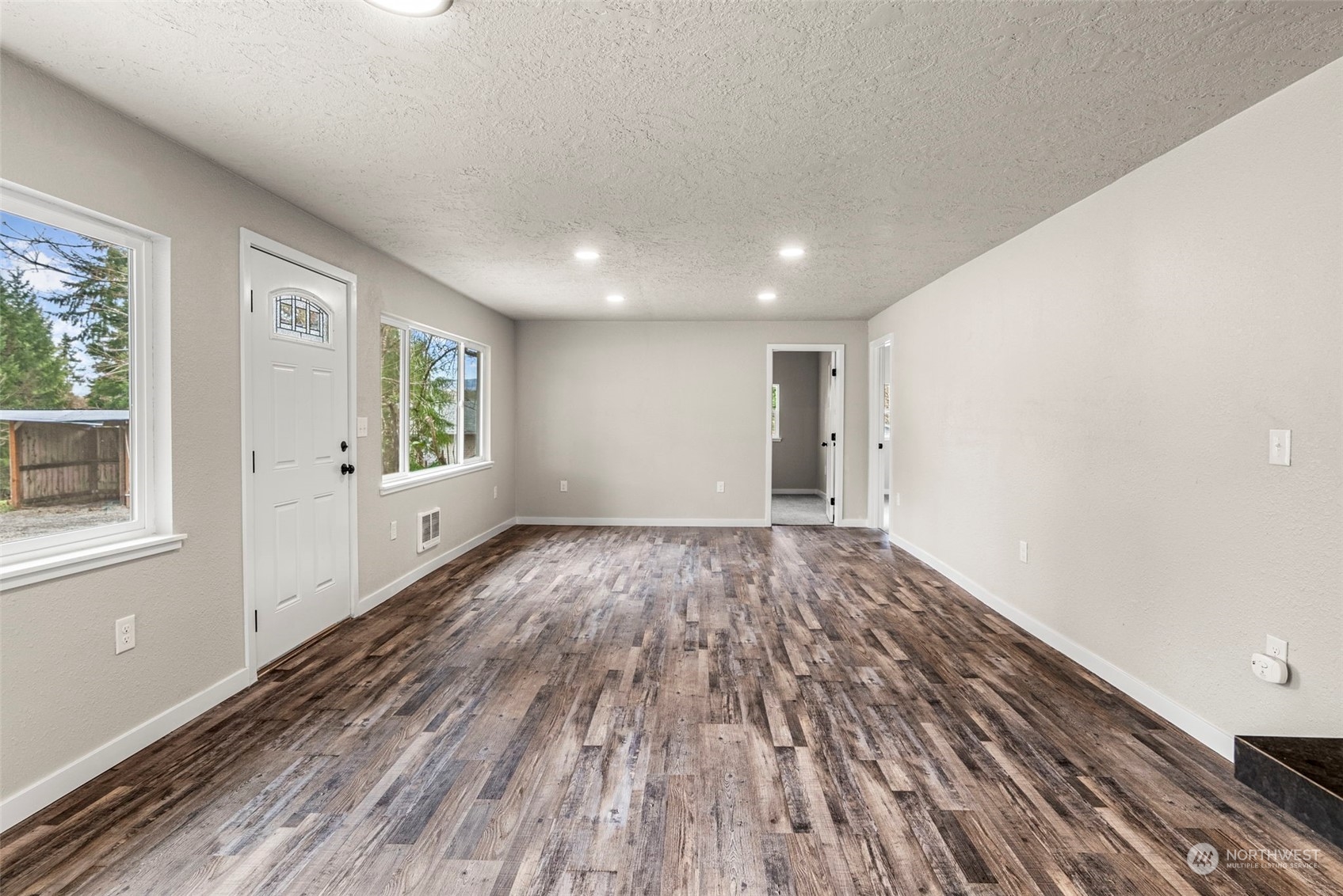 1541 Sightly Road Toutle, WA 98649 - Photo 12 of 30 an empty room with wooden floor and windows