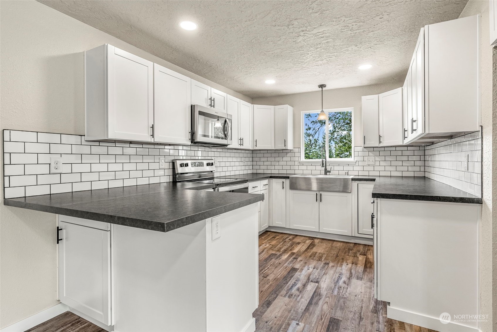 1541 Sightly Road Toutle, WA 98649 - Photo 4 of 30 a kitchen with stainless steel appliances granite countertop a sink a stove and cabinets