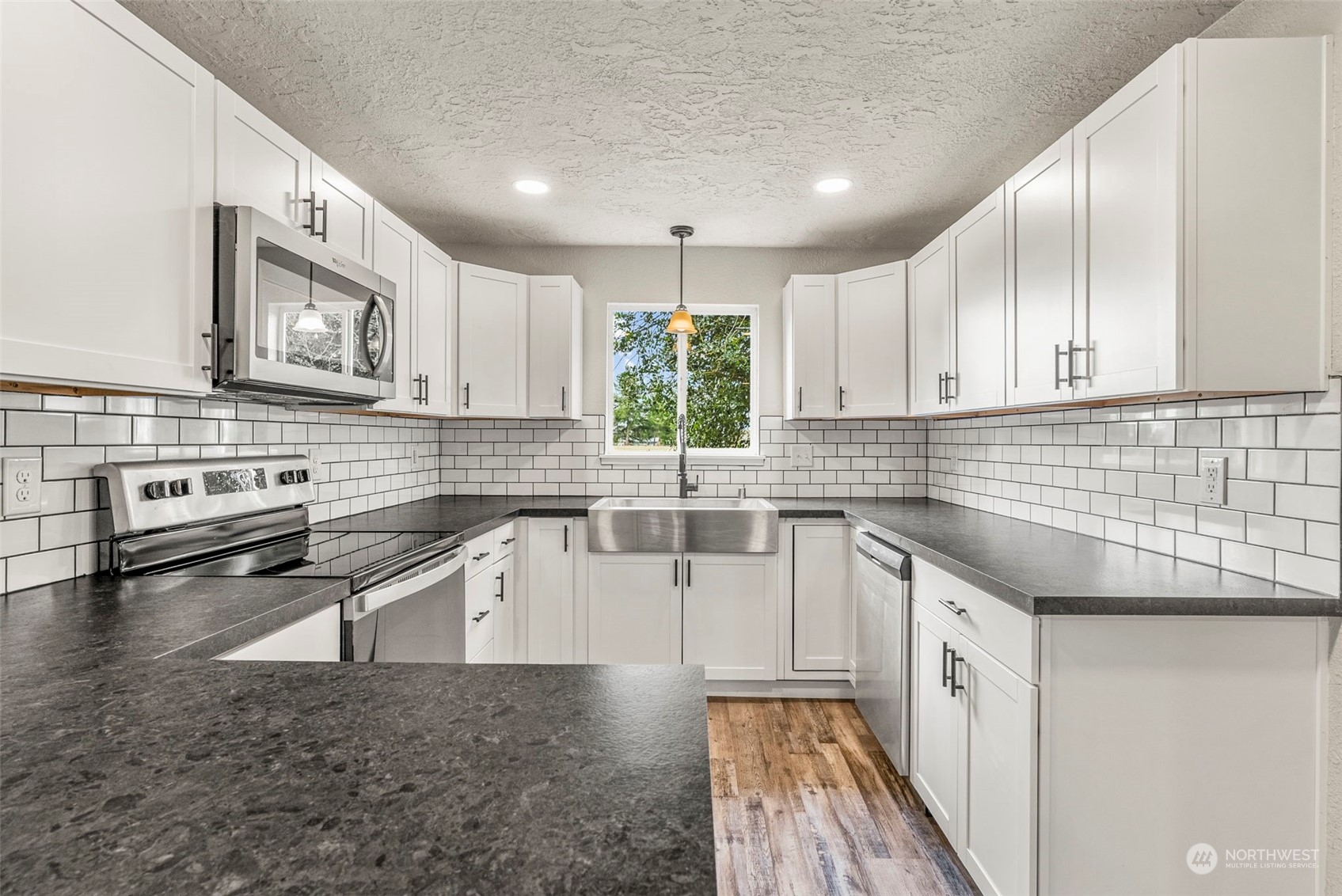 1541 Sightly Road Toutle, WA 98649 - Photo 5 of 30 a kitchen with stainless steel appliances granite countertop a stove a sink and a microwave
