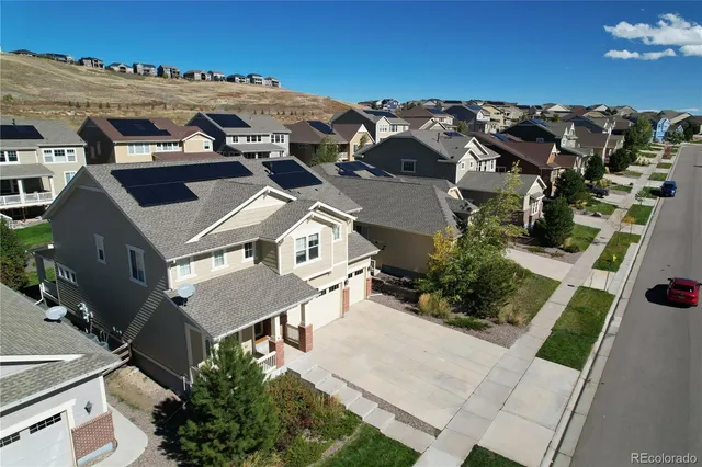 an aerial view of multiple houses with parking