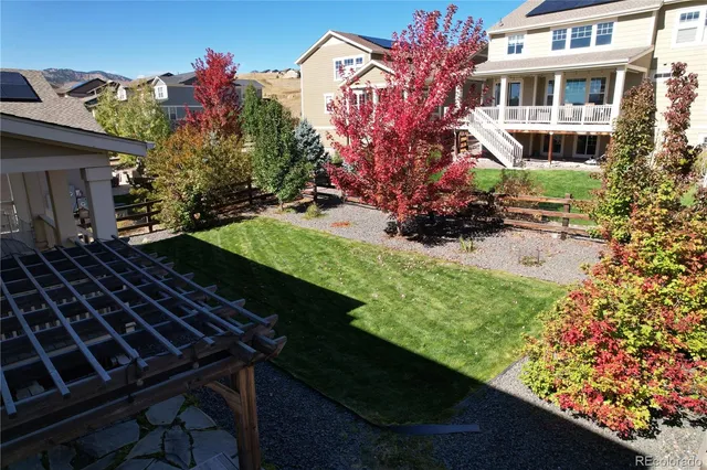 a view of a house with a backyard