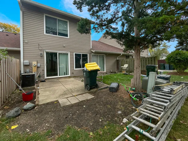 a view of a chairs and table in backyard of the house