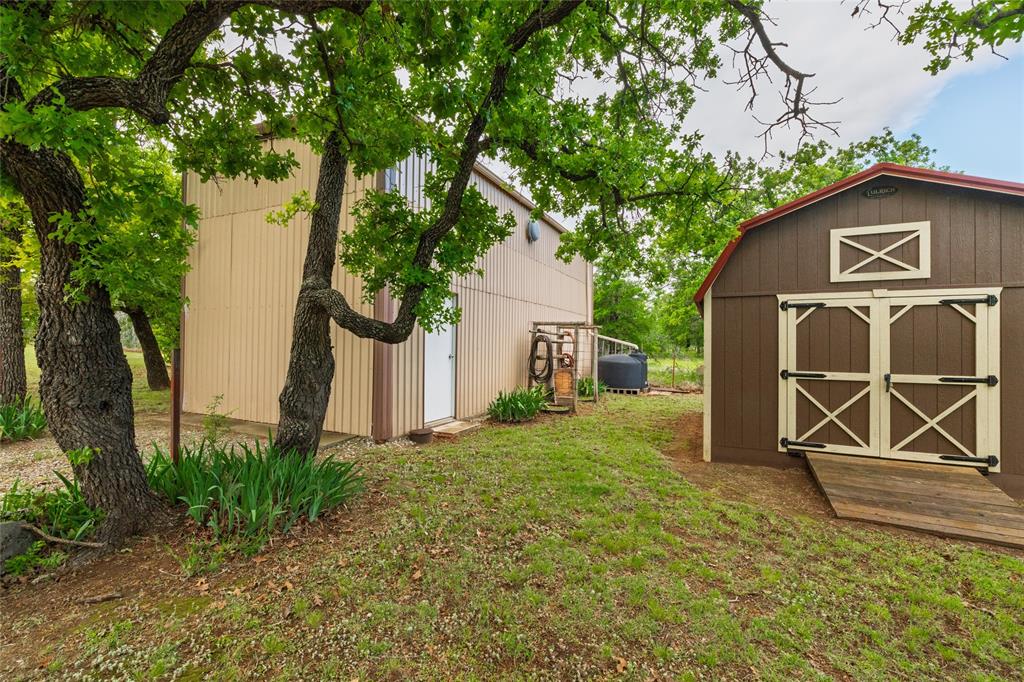 970 Live Oak Road Santo, TX 76472 - Photo 34 of 40 a view of a house with backyard and a tree