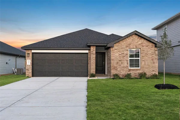 a front view of house with yard and green space