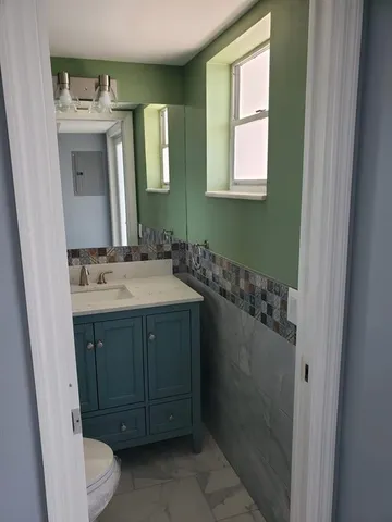 a kitchen with granite countertop a refrigerator and a sink