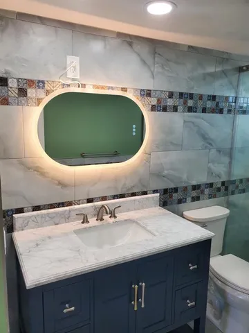 a bathroom with a window sink and cabinets