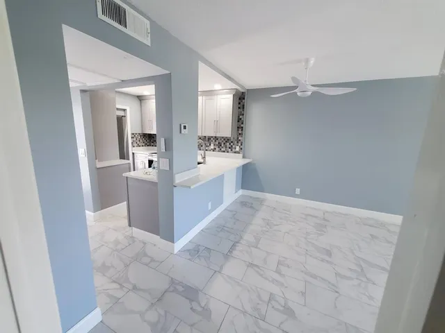 a kitchen with granite countertop a refrigerator and a sink