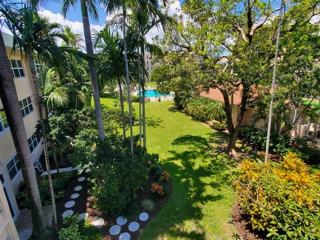 a kitchen with granite countertop white cabinets and stainless steel appliances