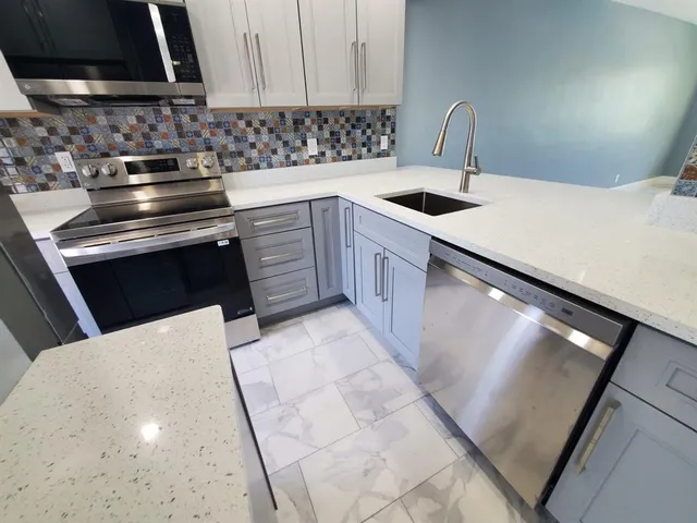 a bathroom with a double vanity sink toilet and mirror