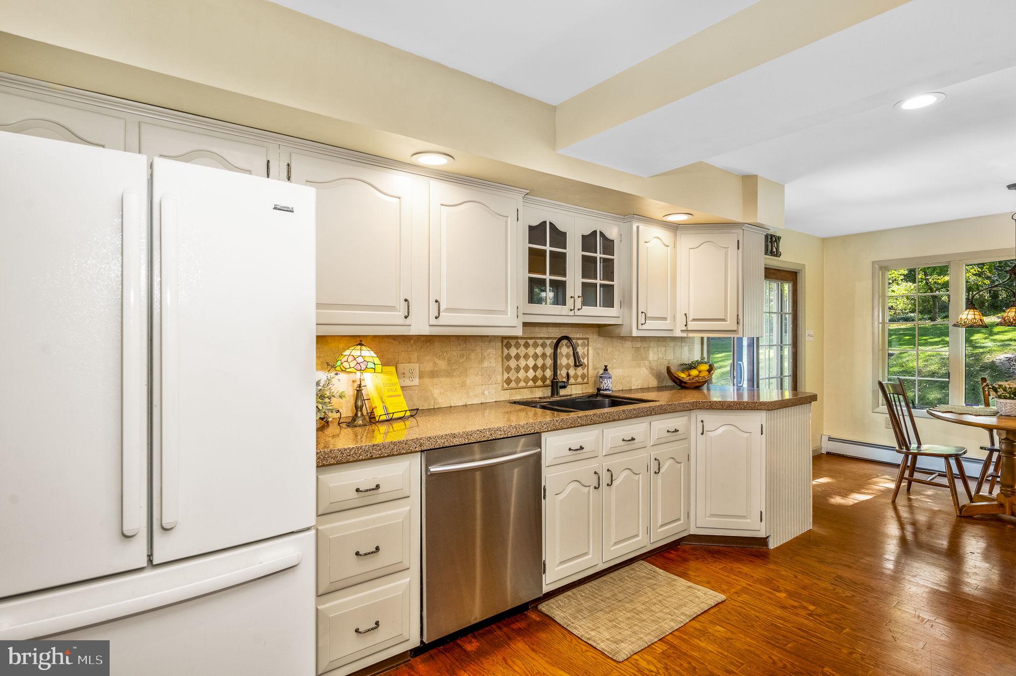 1311 Temple Road Pottstown, PA 19465 - Photo 14 of 49 a kitchen with white cabinets and wooden floor