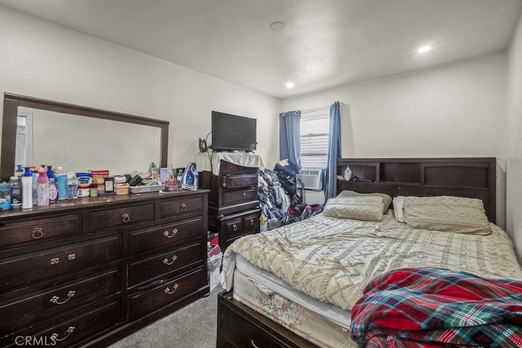 116 North Holly Avenue Compton, CA 90221 - Photo 17 of 23 a bedroom with a bed and a flat screen tv