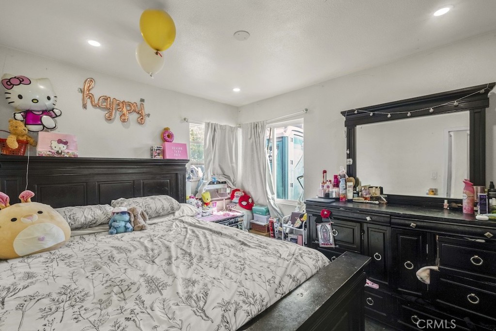 116 North Holly Avenue Compton, CA 90221 - Photo 20 of 23 a bedroom with two beds and a chandelier