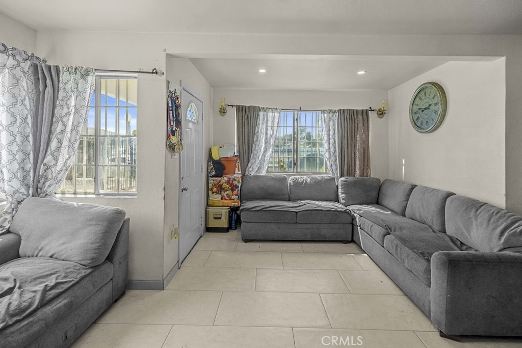116 North Holly Avenue Compton, CA 90221 - Photo 7 of 23 a living room with furniture and a large window
