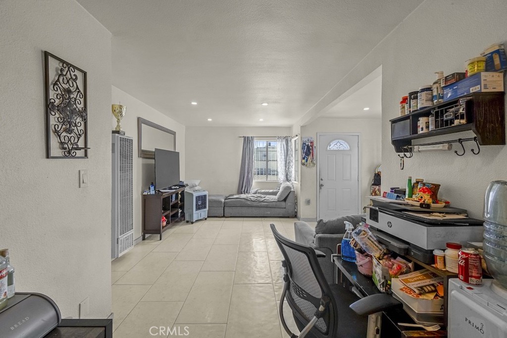 116 North Holly Avenue Compton, CA 90221 - Photo 10 of 23 a living room with furniture and a flat screen tv