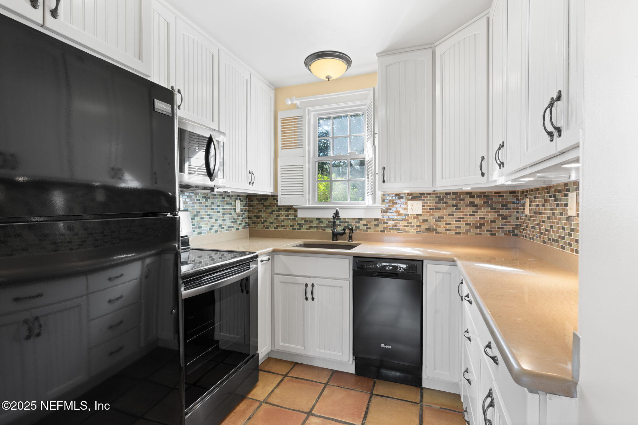 76 Marine Street St. Augustine, FL 32084 - Photo 17 of 60 a kitchen with granite countertop a sink stainless steel appliances and cabinets