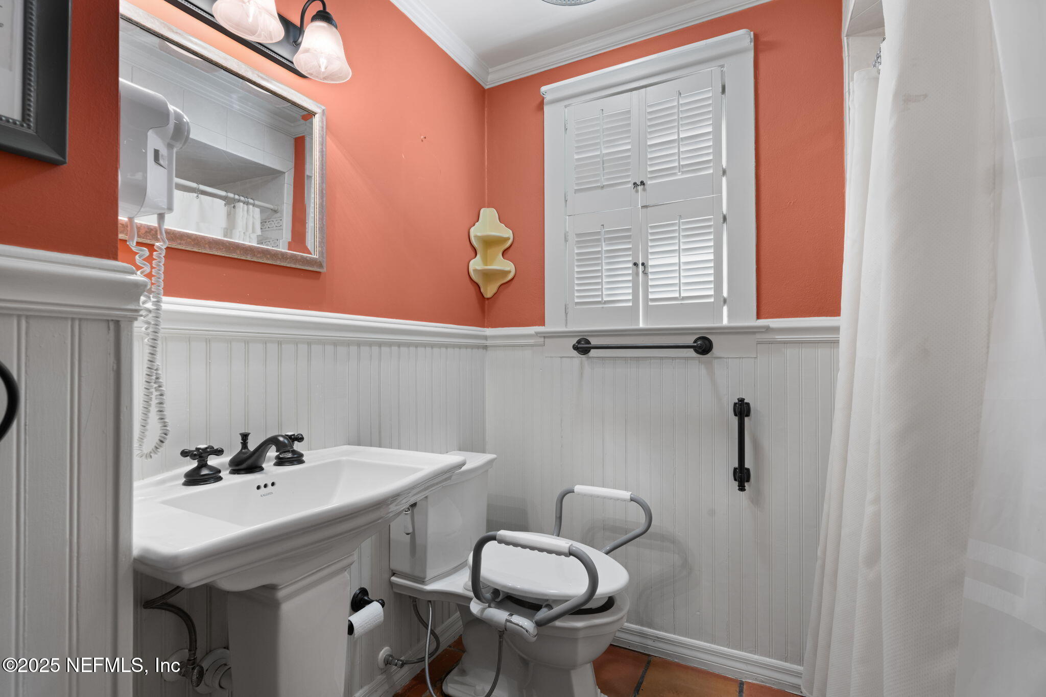 76 Marine Street St. Augustine, FL 32084 - Photo 23 of 60 a bathroom with a sink a toilet and a mirror
