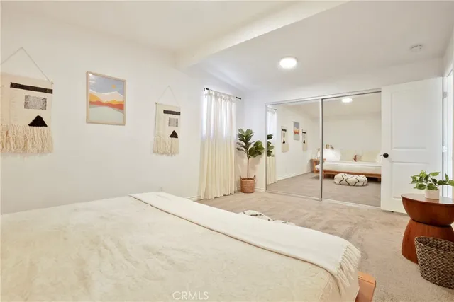 a bedroom with a bed and a couch