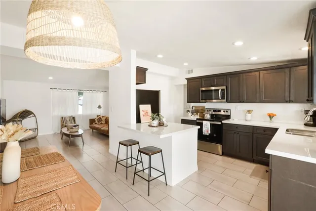 a kitchen with sink refrigerator and stove
