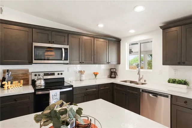 a kitchen with a sink a stove and cabinets