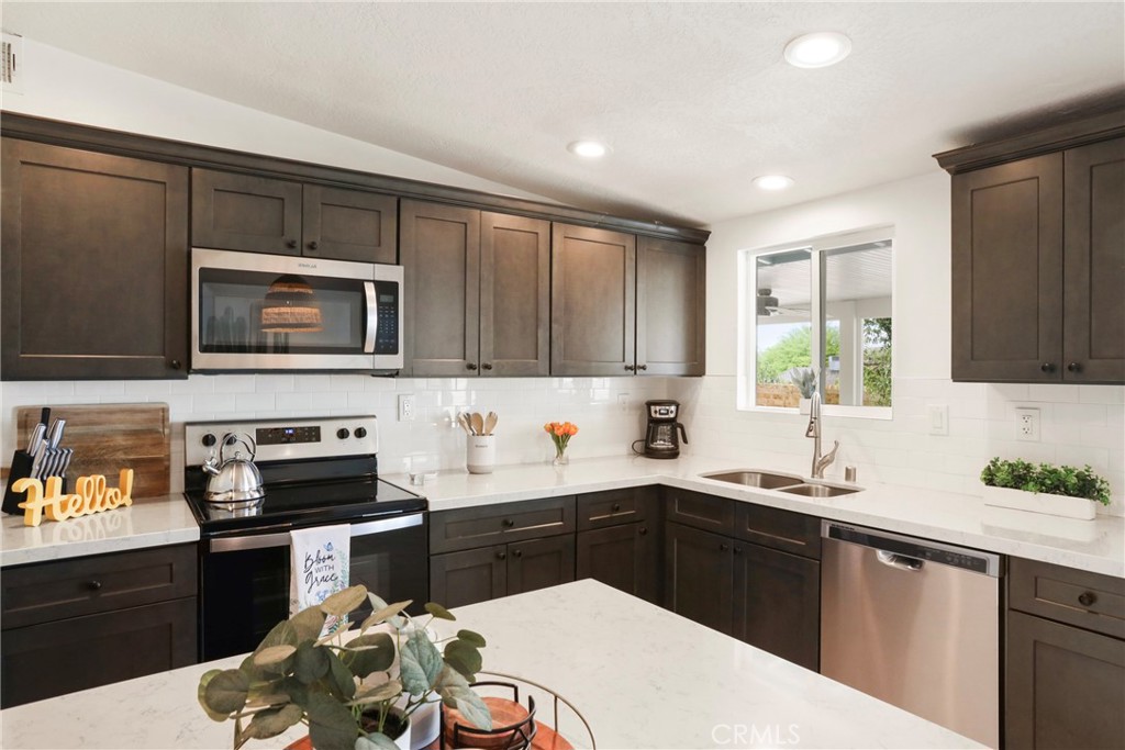 61516 Valley View Drive Joshua Tree, CA 92252 - Photo 15 of 38 a kitchen with a sink a stove and cabinets