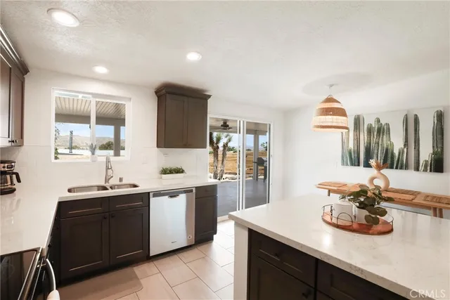 a kitchen with a sink a stove and cabinets