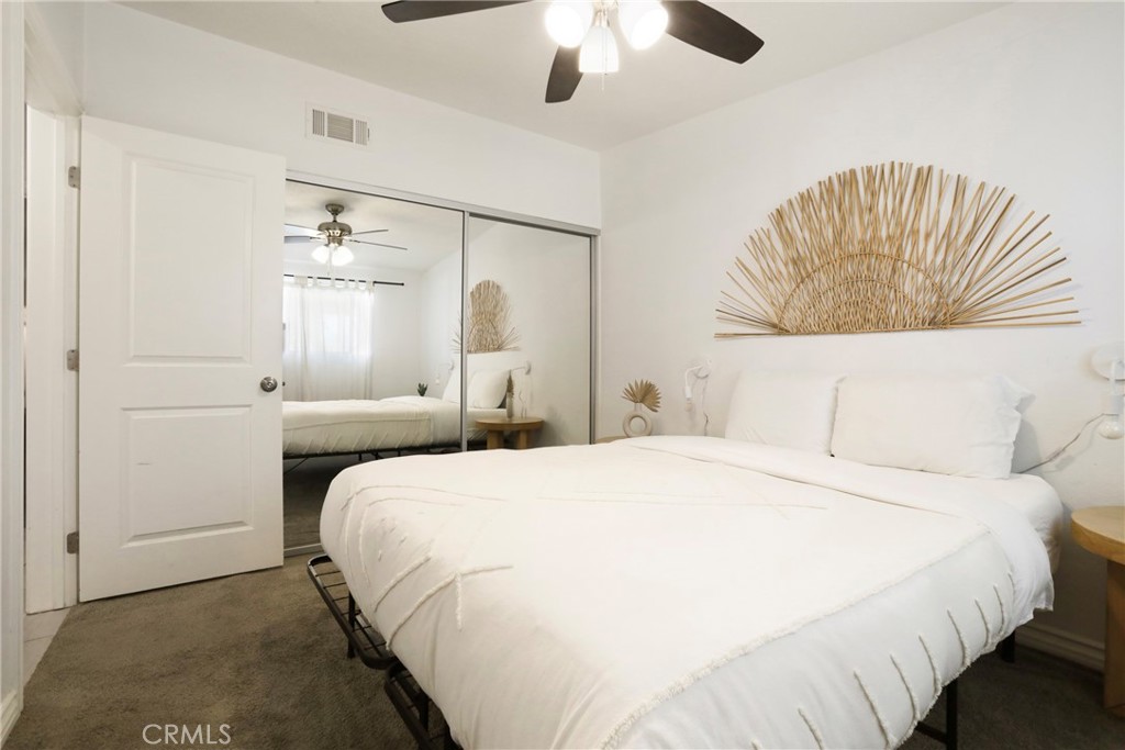 61516 Valley View Drive Joshua Tree, CA 92252 - Photo 17 of 38 a bedroom with a bed and a chandelier