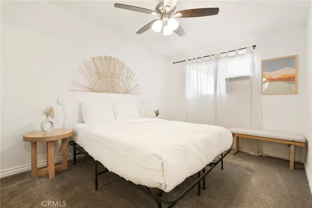 a bedroom with a bed and a table