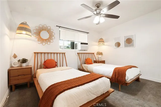 a bedroom with bed and a chandelier