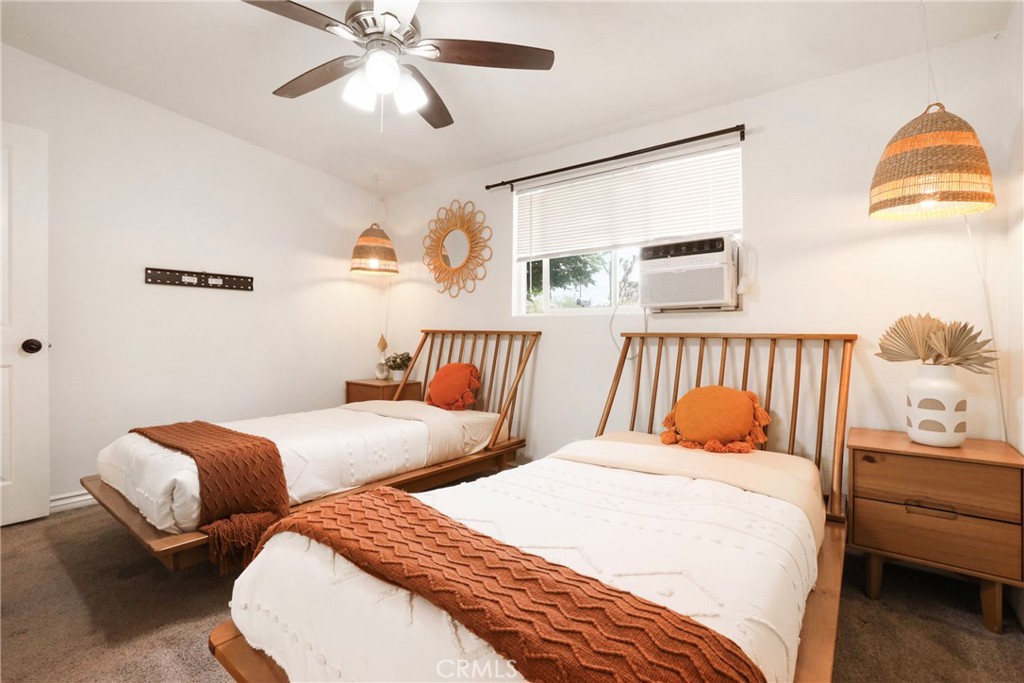 61516 Valley View Drive Joshua Tree, CA 92252 - Photo 22 of 38 a bedroom with two beds and painting on the wall