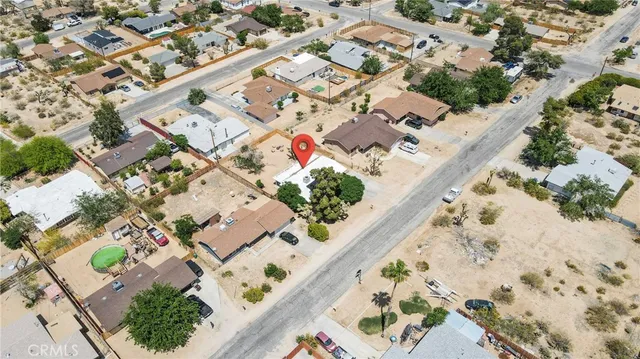 an aerial view of a house with a yard