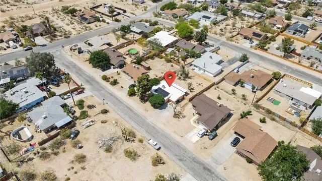 an aerial view of a house with a lot of flowers