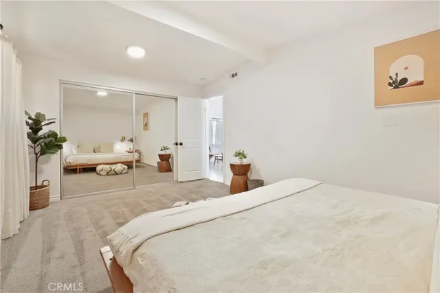 a bedroom with a bed and a couch