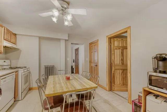 a view of a dining room with furniture and a chandelier
