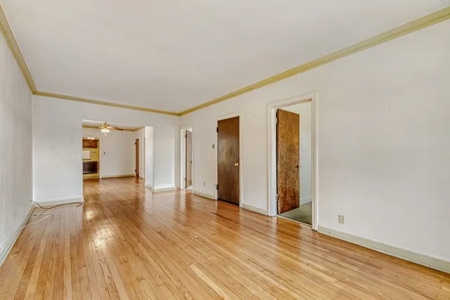 a view of an empty room with wooden floor