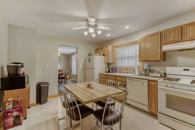a kitchen with a table chairs stove and microwave