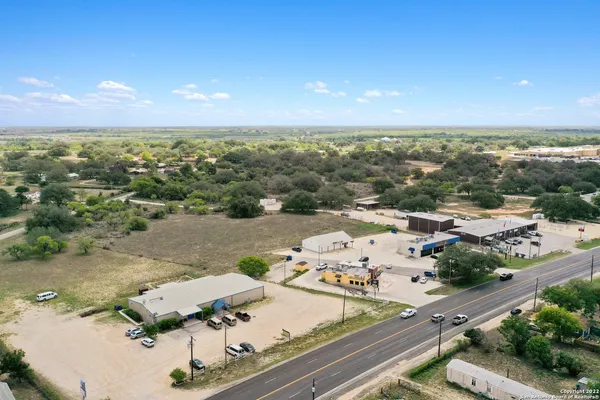 an aerial view of residential houses with outdoor space and seating