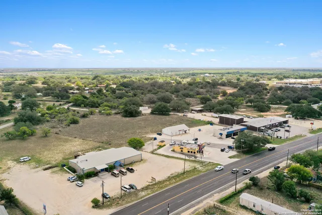 an aerial view of residential houses with outdoor space and seating