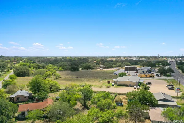 an aerial view of a house with a yard