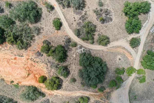 an aerial view of residential house with outdoor space and trees around