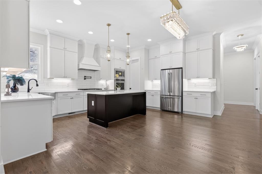 3528 North Bogan Road Buford, GA 30519 - Photo 11 of 79 a kitchen with kitchen island a sink stainless steel appliances and cabinets