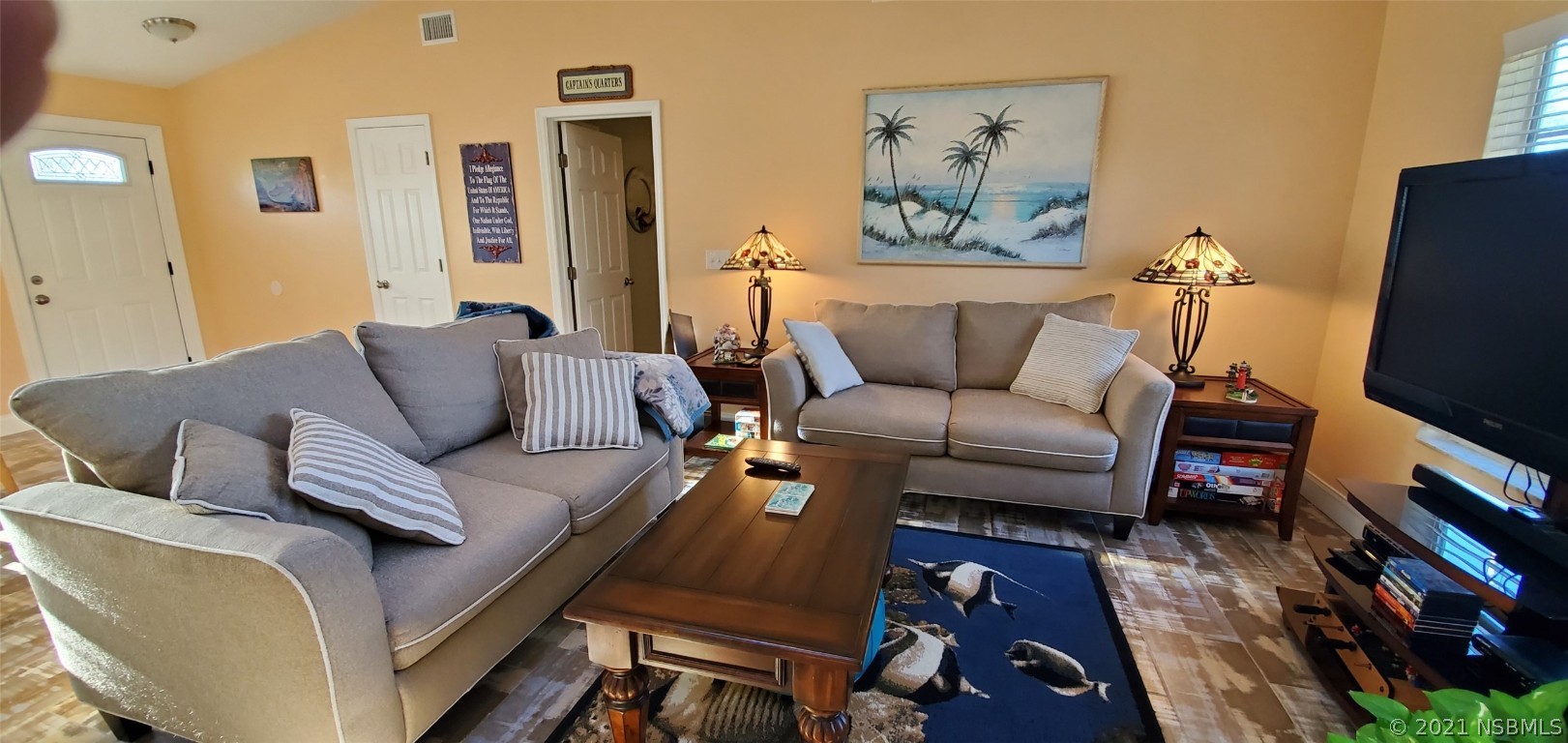 2219 Umbrella Tree Drive Edgewater, FL 32141 - Photo 23 of 45 a living room with furniture and a flat screen tv