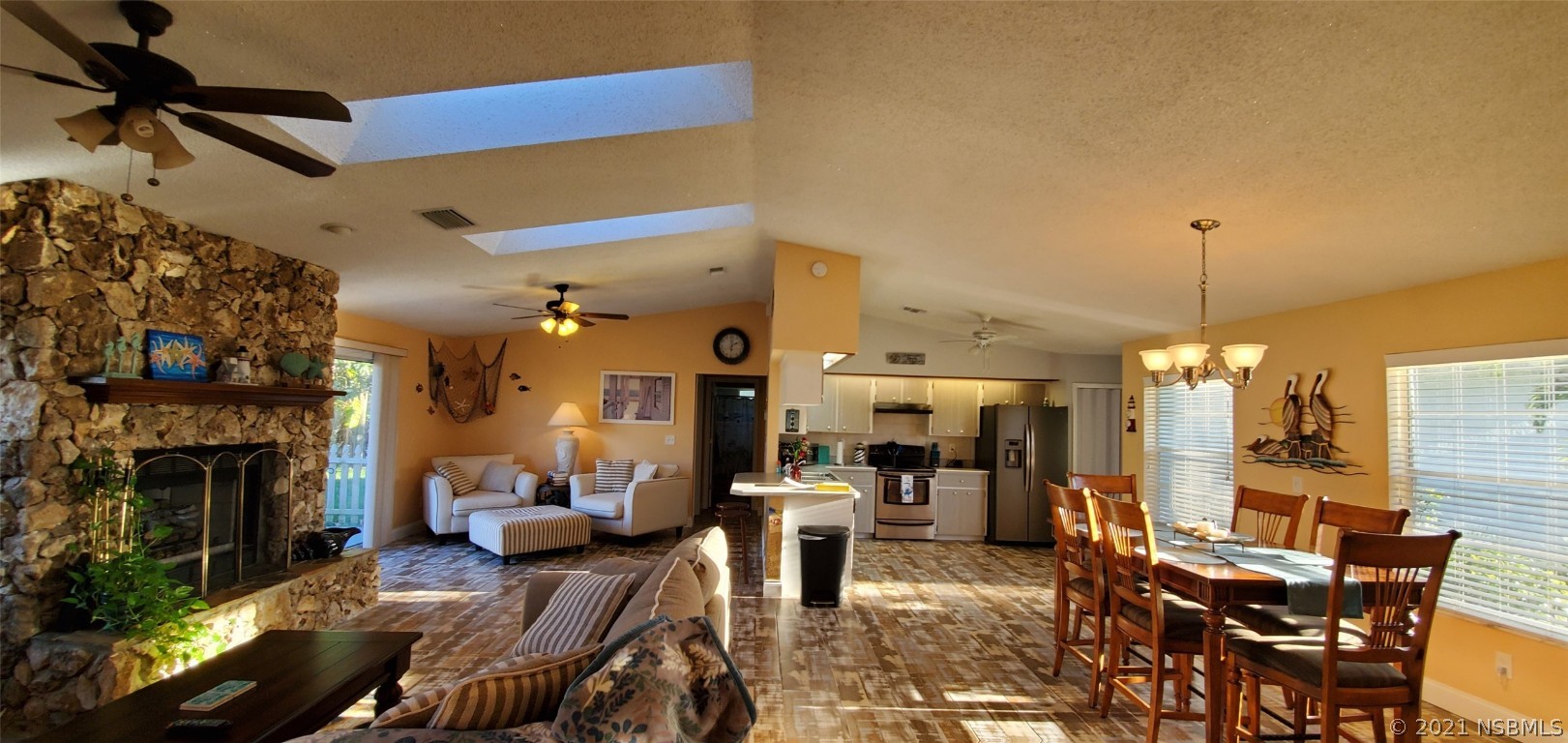 2219 Umbrella Tree Drive Edgewater, FL 32141 - Photo 25 of 45 a living room with furniture a fireplace and a chandelier