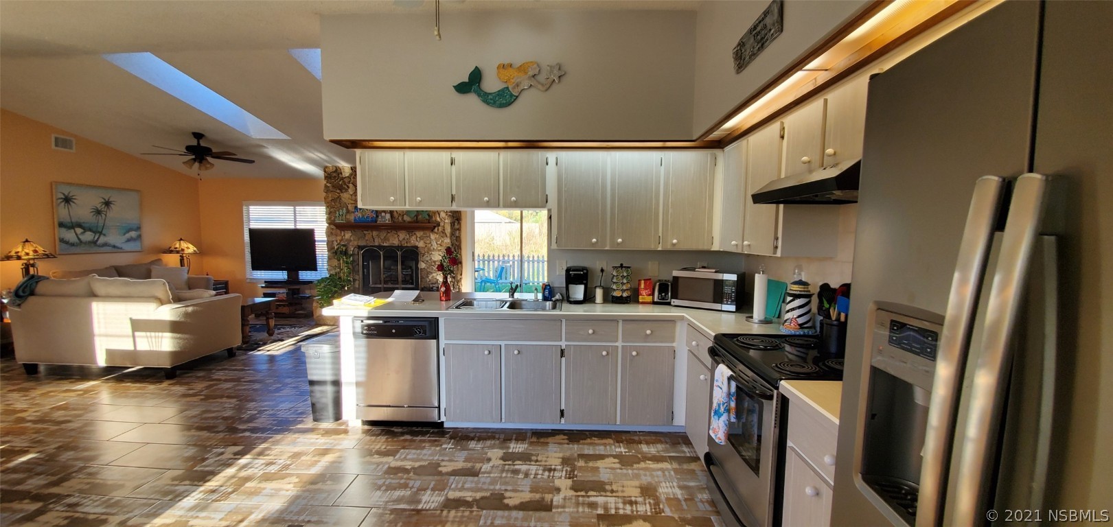 2219 Umbrella Tree Drive Edgewater, FL 32141 - Photo 28 of 45 a kitchen with stainless steel appliances a stove a sink a refrigerator cabinets and wooden floor