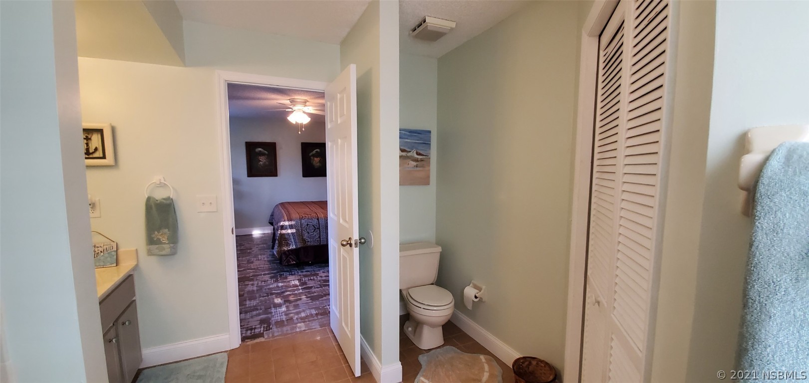 2219 Umbrella Tree Drive Edgewater, FL 32141 - Photo 38 of 45 a bathroom with a granite countertop toilet and a sink